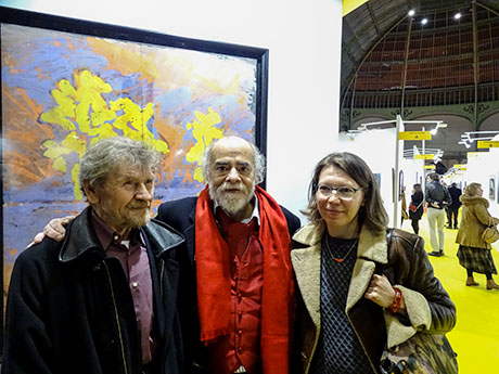 Nikolai Kuzmin with his fellow artist Daniel Gallais and Liubov Kuzmina in front of his work presented in Grand Palais