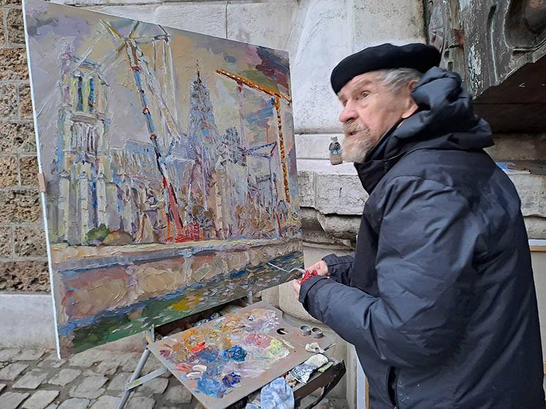 Nikolai Kuzmin painting Notre-Dame de Paris under construction, on February 9, 2024, at the foot of the “Pont au Double”.